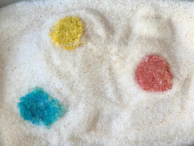 Bowl of Pacha litter with yellow, blue and red crystals showing the 3 health colour codes